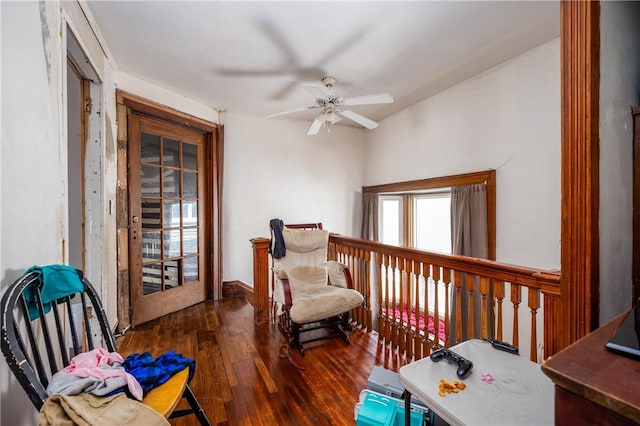 living area featuring a ceiling fan and wood finished floors