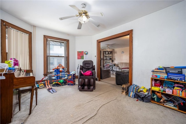 recreation room featuring carpet flooring and a ceiling fan