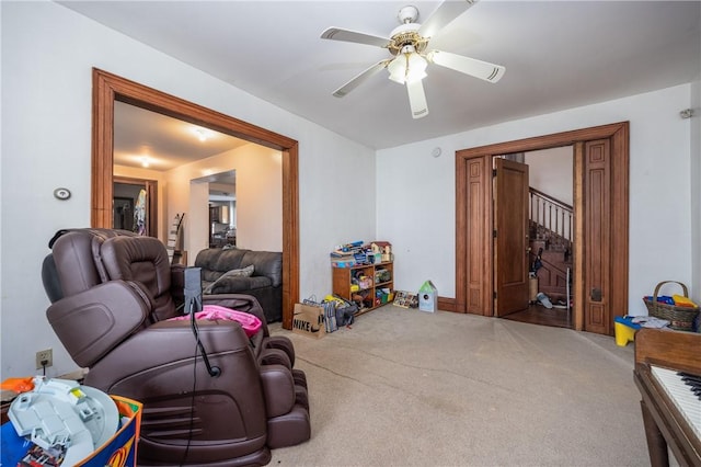 living room with carpet floors and ceiling fan