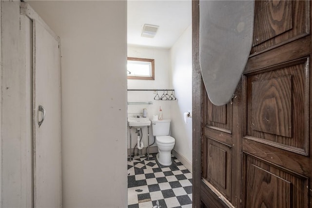 bathroom featuring toilet, tile patterned floors, and visible vents