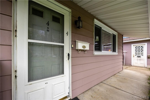 view of exterior entry with a porch