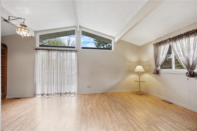 unfurnished room with a wealth of natural light, vaulted ceiling with beams, wood finished floors, and visible vents