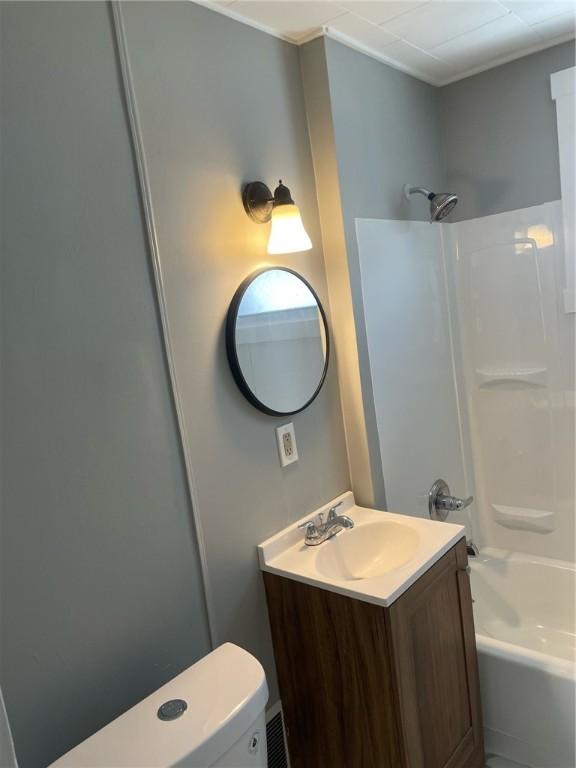 full bath featuring toilet,  shower combination, and vanity