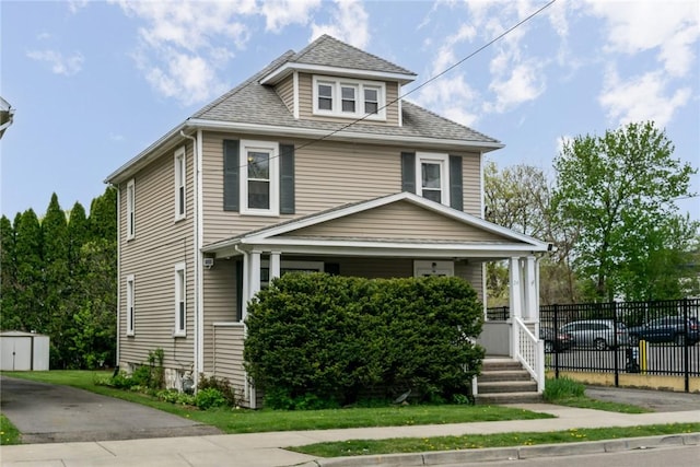 24 Sherman St, Union, NY 13790 - american foursquare style home featuring an outdoor structure, fence, covered porch, a shed, and a shingled roof