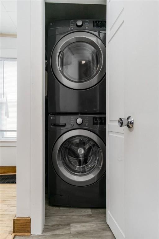 24 Sherman St, Union, NY 13790 - clothes washing area with baseboards, wood finished floors, and stacked washer / dryer