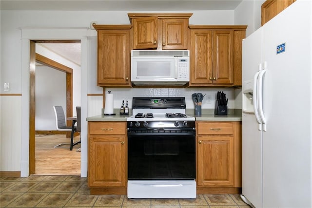 24 Sherman St, Union, NY 13790 - kitchen with light countertops, baseboards, brown cabinetry, and white appliances