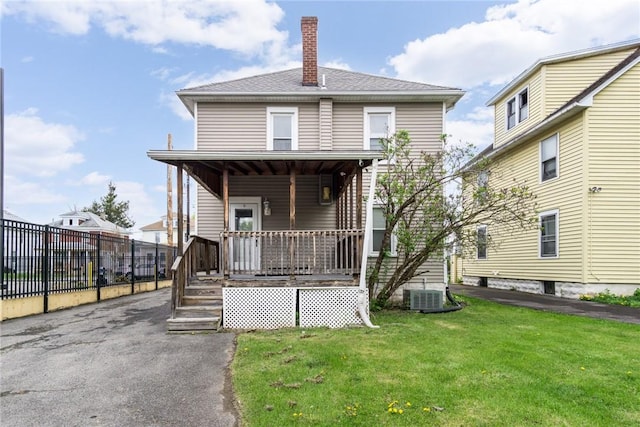 24 Sherman St, Union, NY 13790 - traditional style home with covered porch, a chimney, fence, cooling unit, and a front lawn