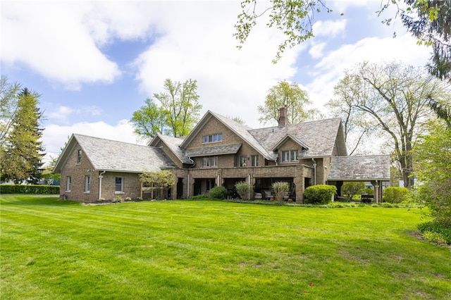 43 S Main St, Elba, NY 14058 - rear view of house featuring a chimney, a yard, and brick siding