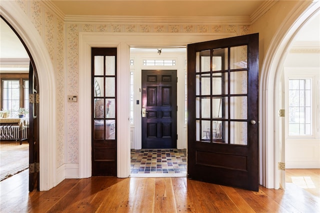 43 S Main St, Elba, NY 14058 - entryway featuring hardwood / wood-style flooring, wallpapered walls, ornamental molding, arched walkways, and radiator heating unit
