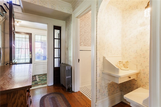 43 S Main St, Elba, NY 14058 - entryway featuring radiator heating unit, wallpapered walls, dark wood finished floors, and ornamental molding