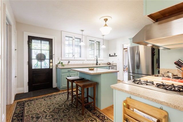 43 S Main St, Elba, NY 14058 - kitchen with freestanding refrigerator, island exhaust hood, green cabinetry, and light wood finished floors