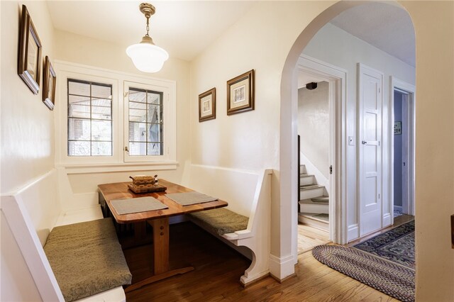 43 S Main St, Elba, NY 14058 - dining space featuring arched walkways, wood finished floors, and stairs