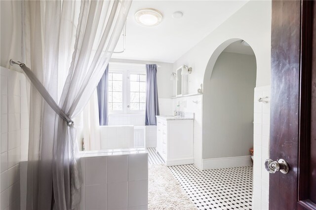 43 S Main St, Elba, NY 14058 - full bathroom with vanity, tiled tub, and tile walls
