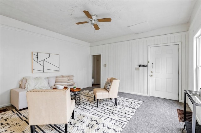 living area featuring carpet floors and ceiling fan