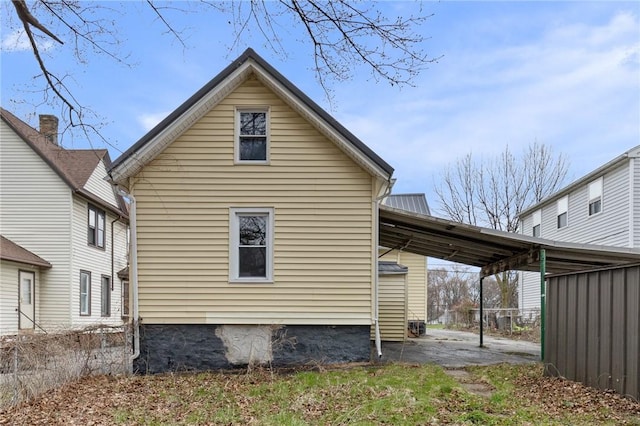 view of side of property with a carport