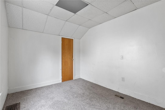 empty room featuring carpet flooring, visible vents, and a paneled ceiling