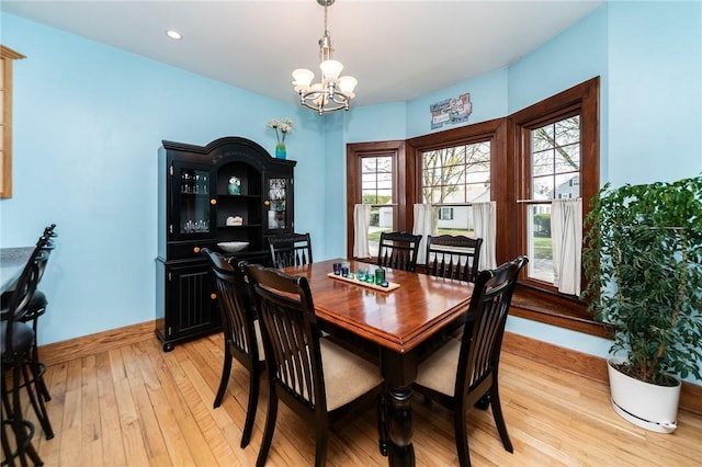 dining room featuring baseboards, recessed lighting, light wood-style flooring, and a notable chandelier