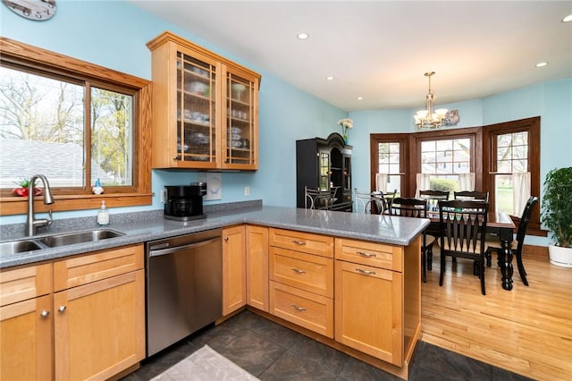 kitchen featuring plenty of natural light, a sink, a peninsula, and dishwasher