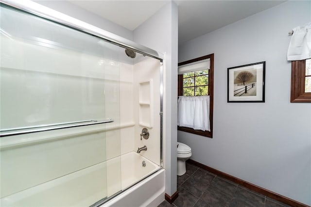 full bathroom with baseboards, combined bath / shower with glass door, and toilet