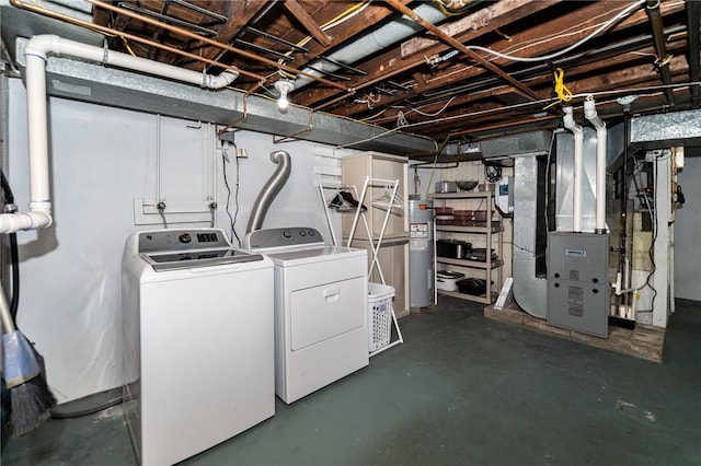 laundry area featuring laundry area, heating unit, washer and clothes dryer, and water heater