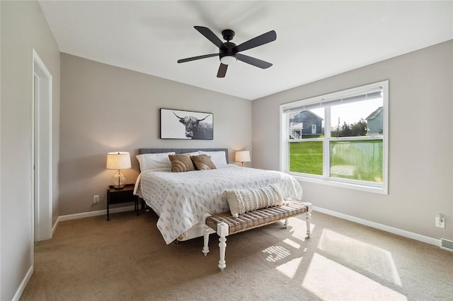 carpeted bedroom with baseboards, visible vents, and ceiling fan