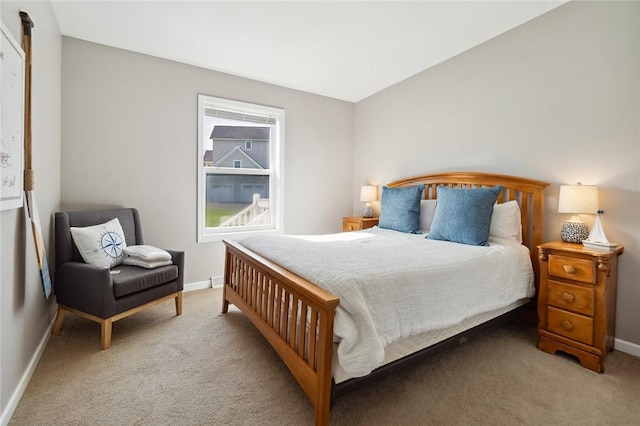 bedroom with baseboards and carpet