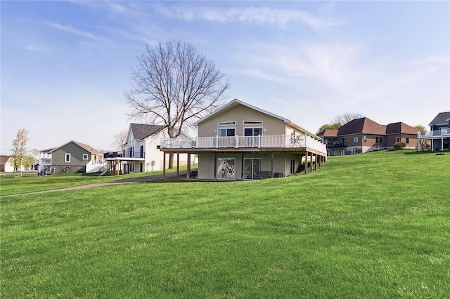 back of house with a lawn, a wooden deck, and a residential view