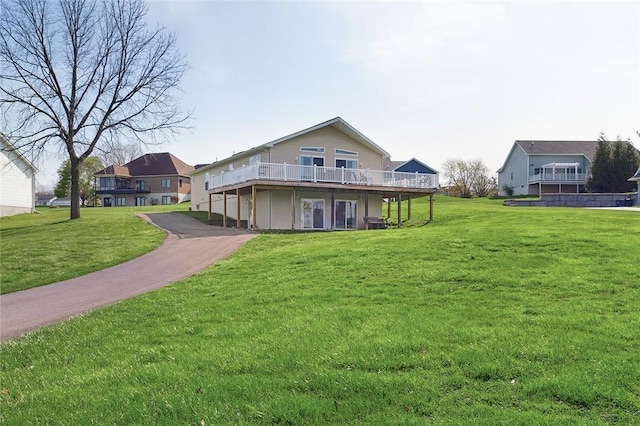view of front of property with a front yard and a deck