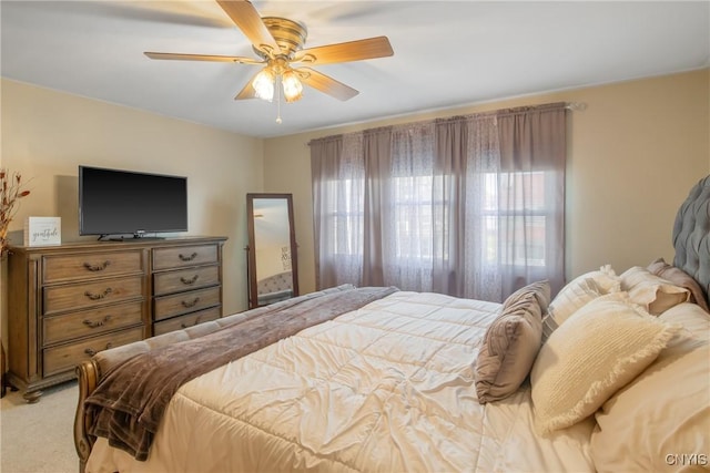 bedroom featuring a ceiling fan and light carpet
