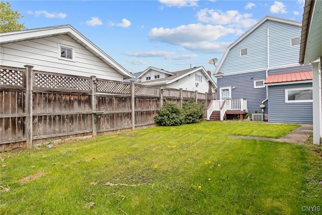 view of yard with central air condition unit, fence, and a wooden deck