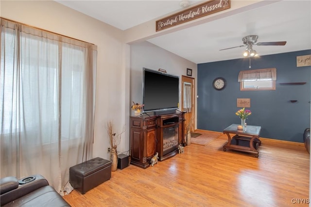 living room with ceiling fan and wood finished floors