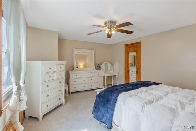 bedroom with ceiling fan and light colored carpet