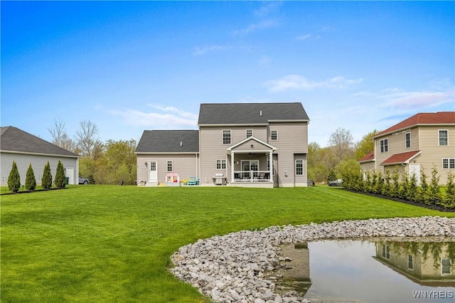 rear view of property featuring a yard and a patio