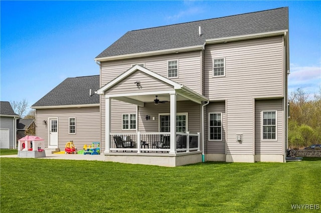 back of house featuring a ceiling fan, a patio, and a lawn
