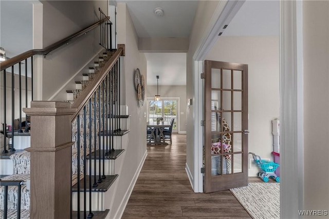 foyer with baseboards, stairway, french doors, and wood finished floors