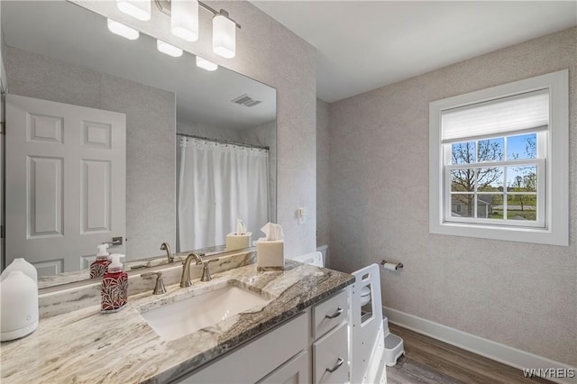 full bathroom featuring wood finished floors, baseboards, vanity, and a shower with curtain