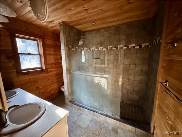 bathroom featuring a shower stall, wooden walls, wooden ceiling, and a sink