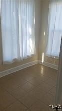 spare room with baseboards