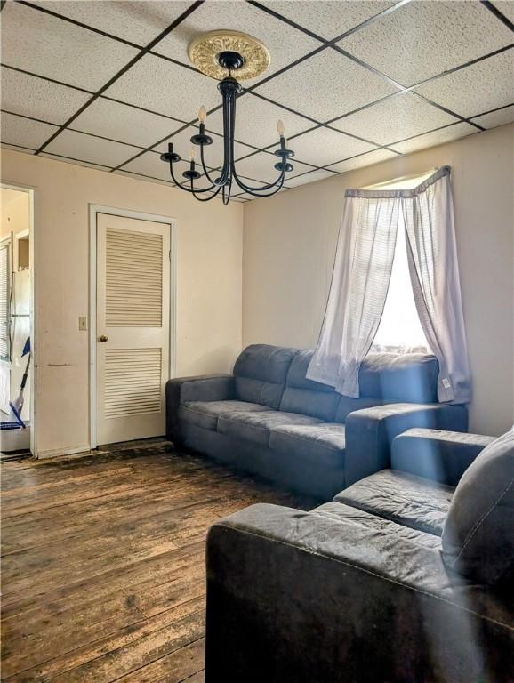 603 W 2nd St, Elmira-City, NY 14905 - living room with a drop ceiling, dark wood-style floors, and a chandelier