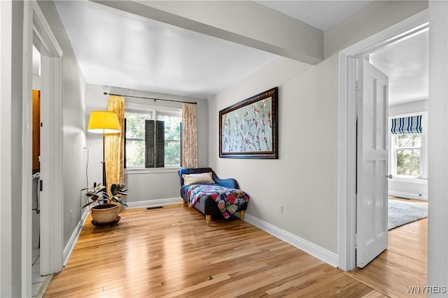 bedroom featuring baseboards, multiple windows, wood finished floors, and visible vents