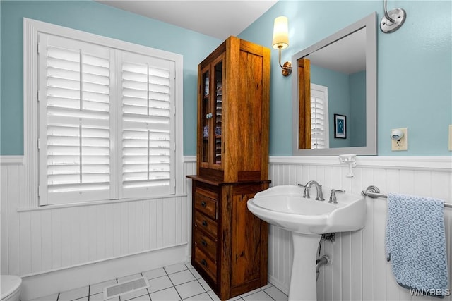 bathroom featuring tile patterned floors and wainscoting