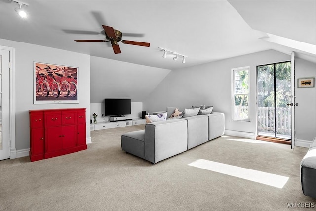 living room featuring carpet flooring, a ceiling fan, rail lighting, and vaulted ceiling