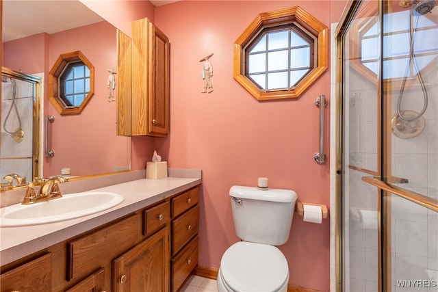 full bathroom with vanity, toilet, and a tile shower