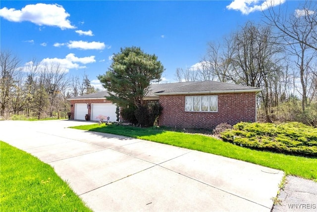 ranch-style home featuring a garage, concrete driveway, a front lawn, and brick siding