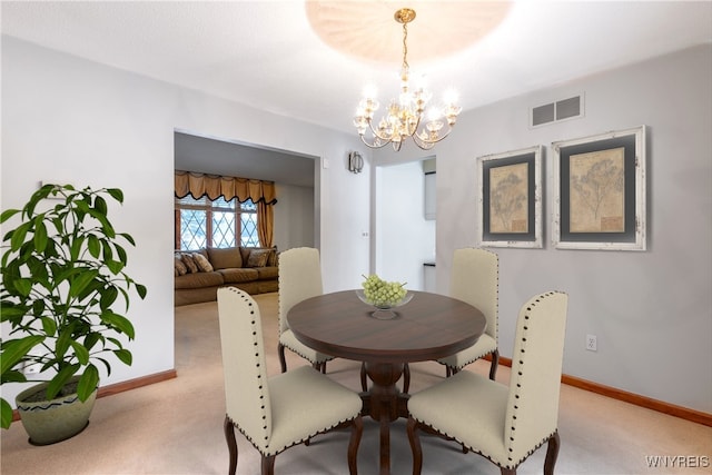 dining area featuring carpet flooring, a notable chandelier, visible vents, and baseboards