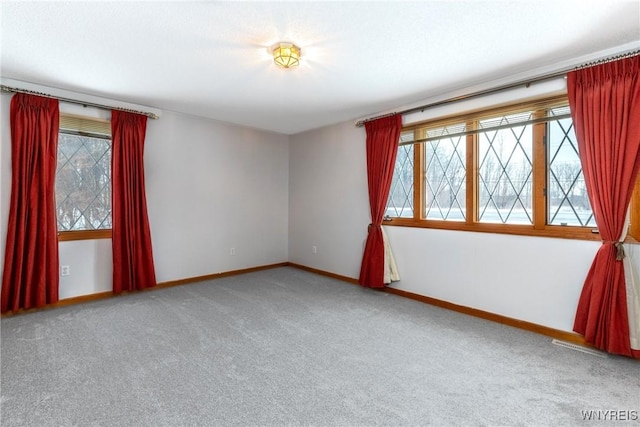 empty room with carpet flooring and baseboards