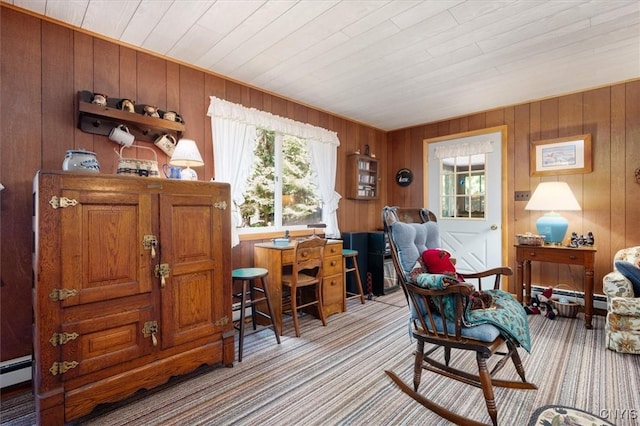 living area with light colored carpet, wooden walls, and baseboard heating