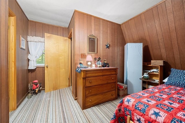 carpeted bedroom featuring wood walls