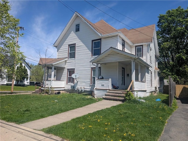 1144 Oak St, Elmira-City, NY 14901 - view of front facade with a porch, a shingled roof, fence, and a front yard