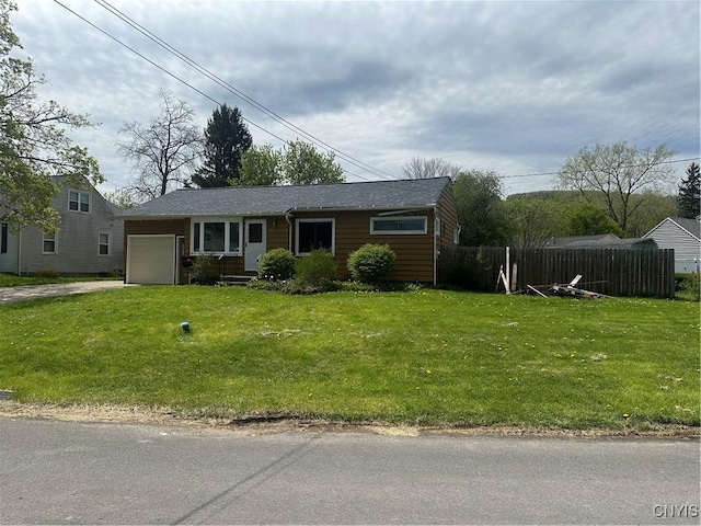 ranch-style house with a garage, fence, driveway, and a front lawn